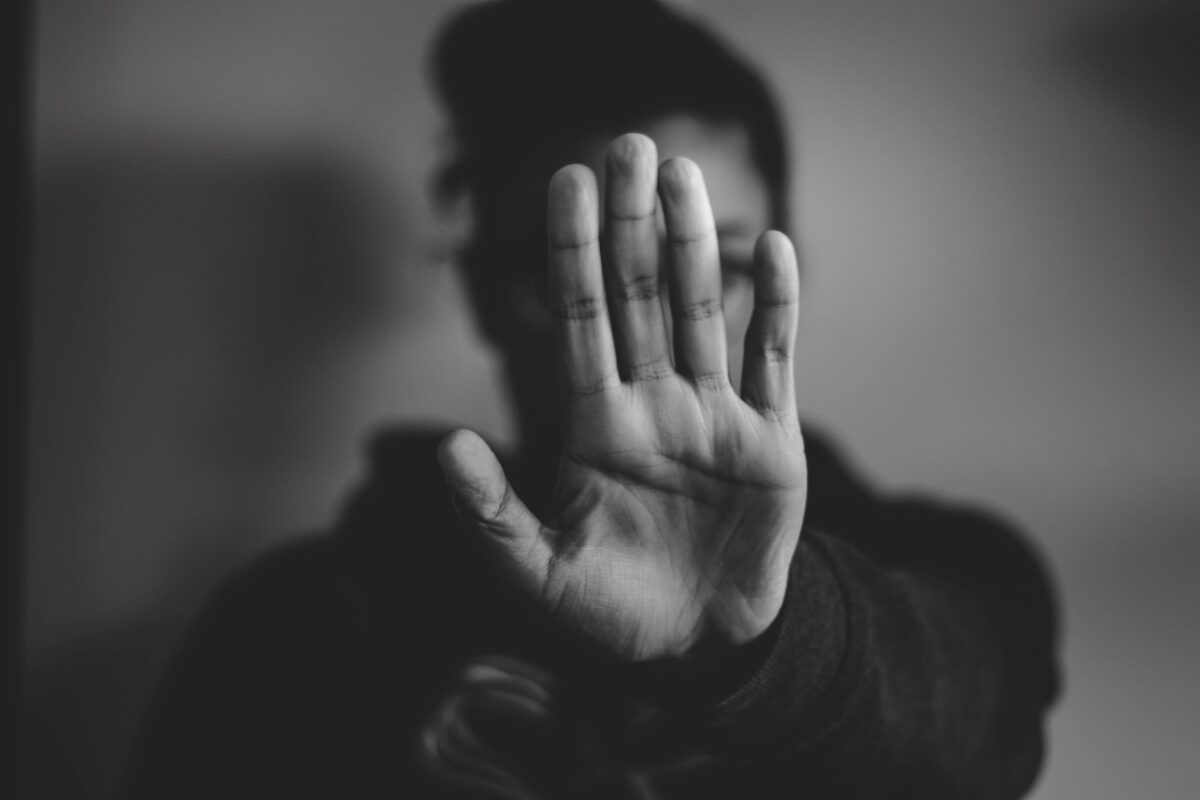 A hand held up towards the camera in a gesture of refusal