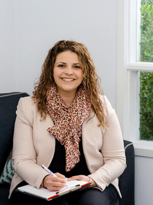 Maria Kampantais seated and smiling