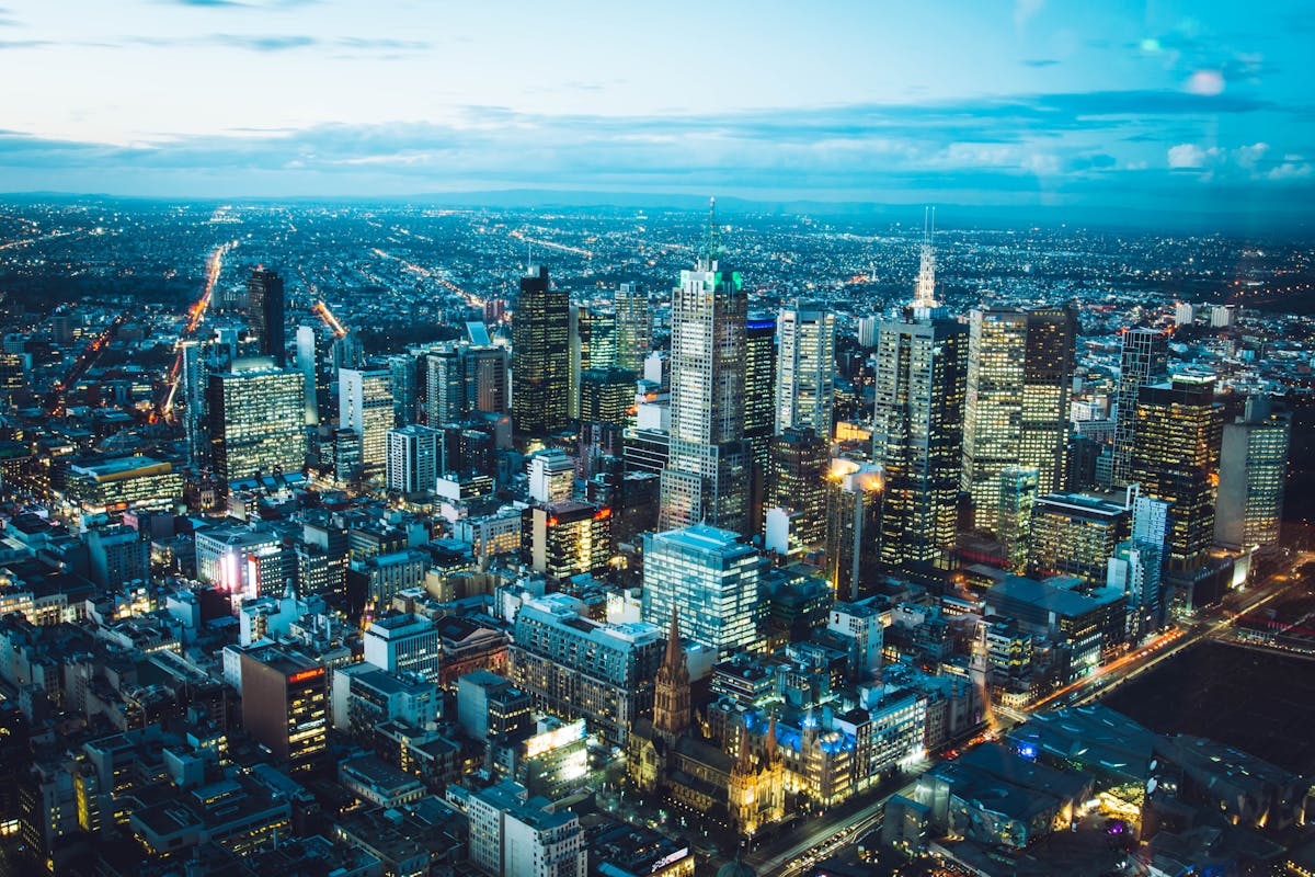 A breathtaking aerial view of Melbourne's illuminated skyline with modern skyscrapers at night.