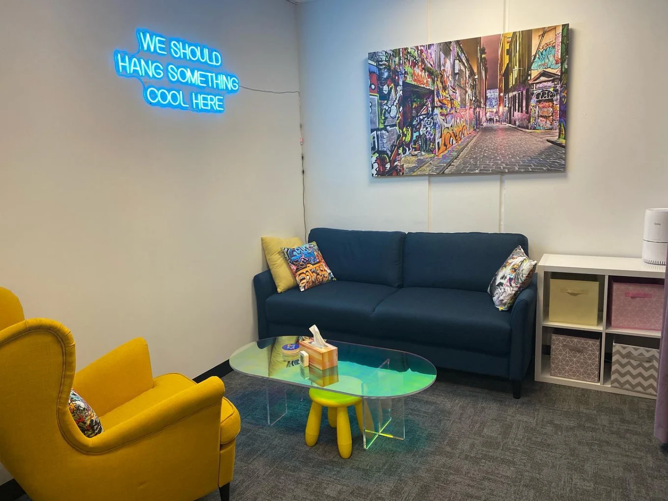 A shared breakout space with a sofa, armchair and coffee table for practitioners