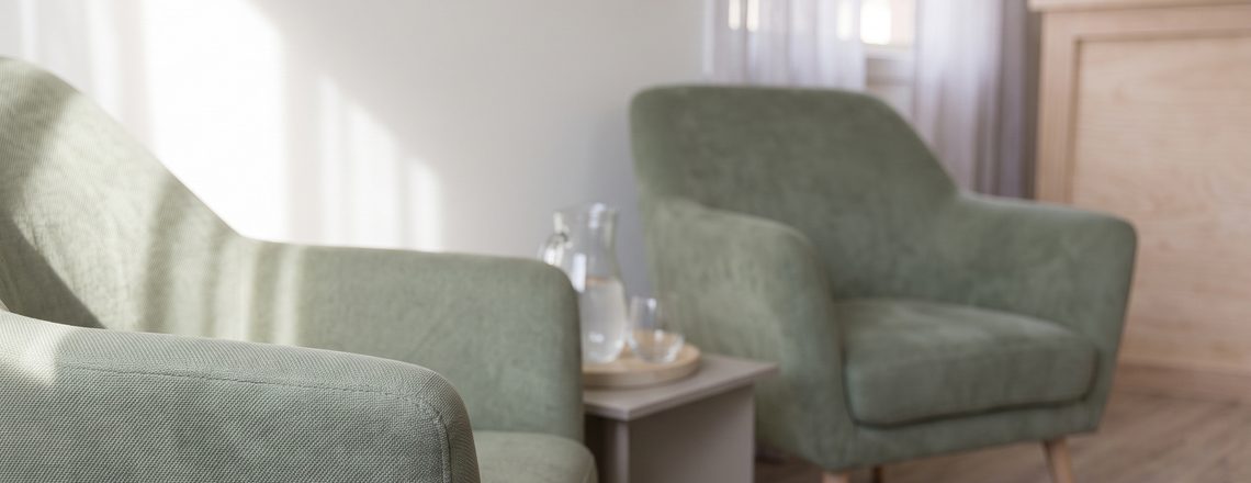 A quiet seating area with two soft armchairs and a jug of water at Your Mind Matters in Notting Hill